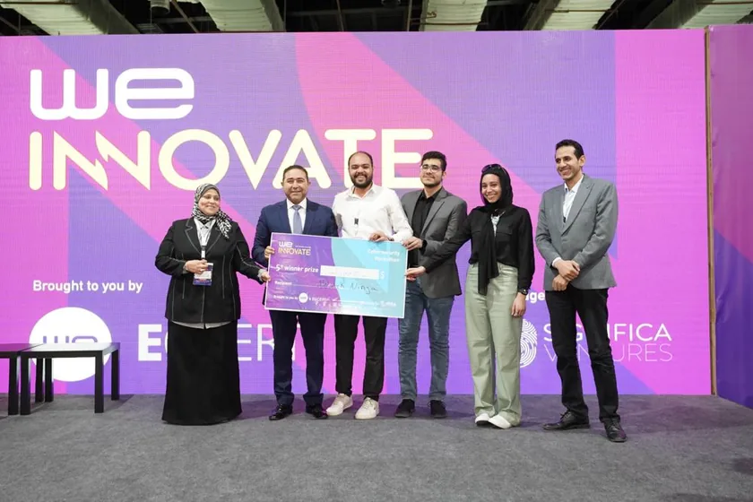 A winning team receiving its award on stage