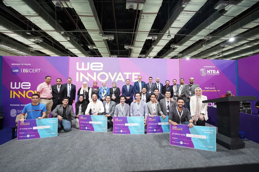 Hackathon teams, mentors and organisers on stage with their awards
